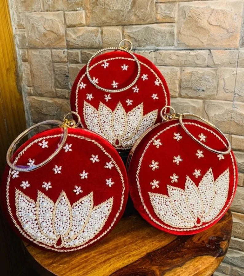 Red round clutch with white lotus beadwork with bangle