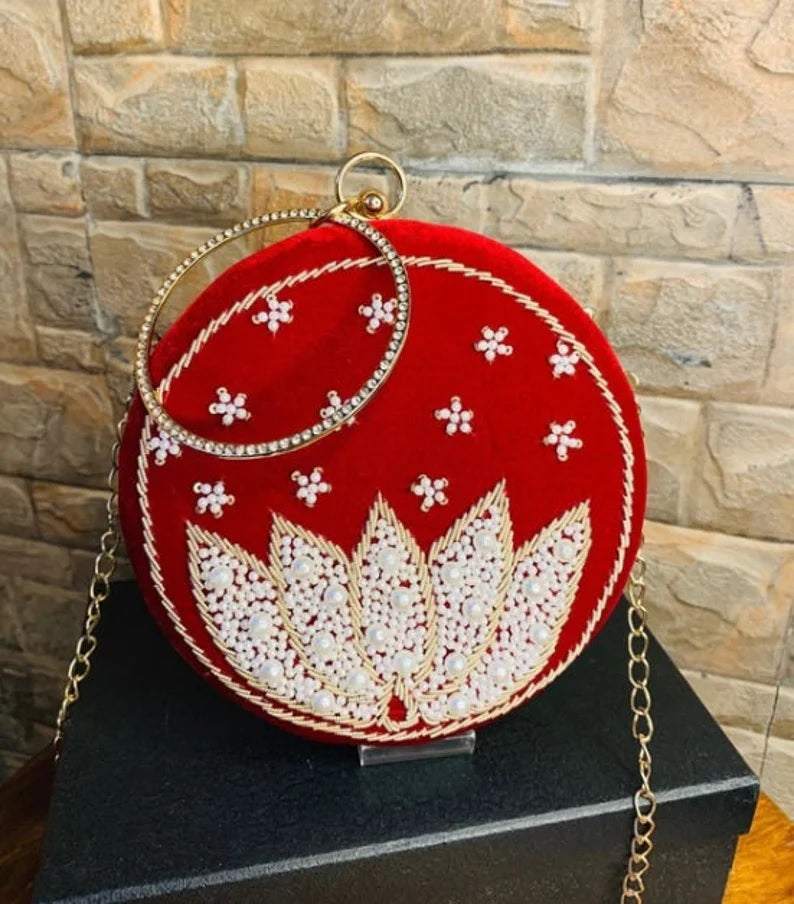 Red round clutch with white lotus beadwork with bangle